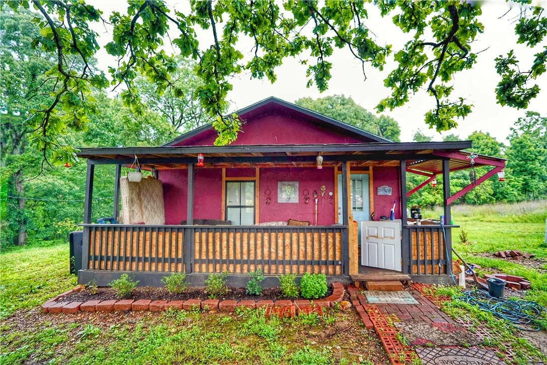 Small home with 5 acres of unrestricted land in Rogers! Escape the everyday on this peaceful 5-acre property. Featuring a simple, small home, this is your opportunity to embrace country living with the convenience of being a few minutes away from Downtown Rogers. Imagine the possibilities for gardening, recreation, or simply enjoying the space and privacy, all within reach of city amenities.