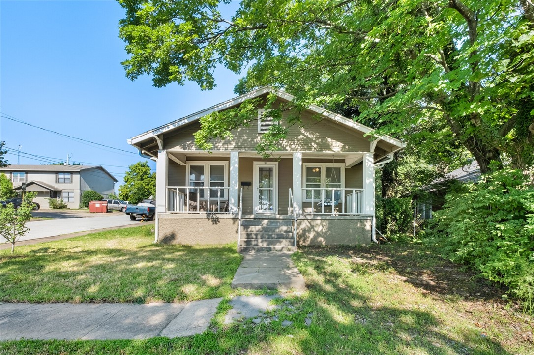 ATTN INVESTORS & U of A STUDENTS! If you are looking for a house close to campus, look no further than this beauty! Home sits on a LARGE LOT only a couple blocks from Campus. Current owners parked cars on their gravel lot on game days$$ Three bedrooms, one bath with large living room & dining room and large eat in kitchen with bountiful cabinets for storage. Beautiful hardwood floors, arched doorways, solid wood doors. Laundry room is huge with plenty of room for bicycles, scooters or a desk for your studies! Adorable front porch where you can sit and listen to Old Main's bell. This 1920's charmer won't last long.