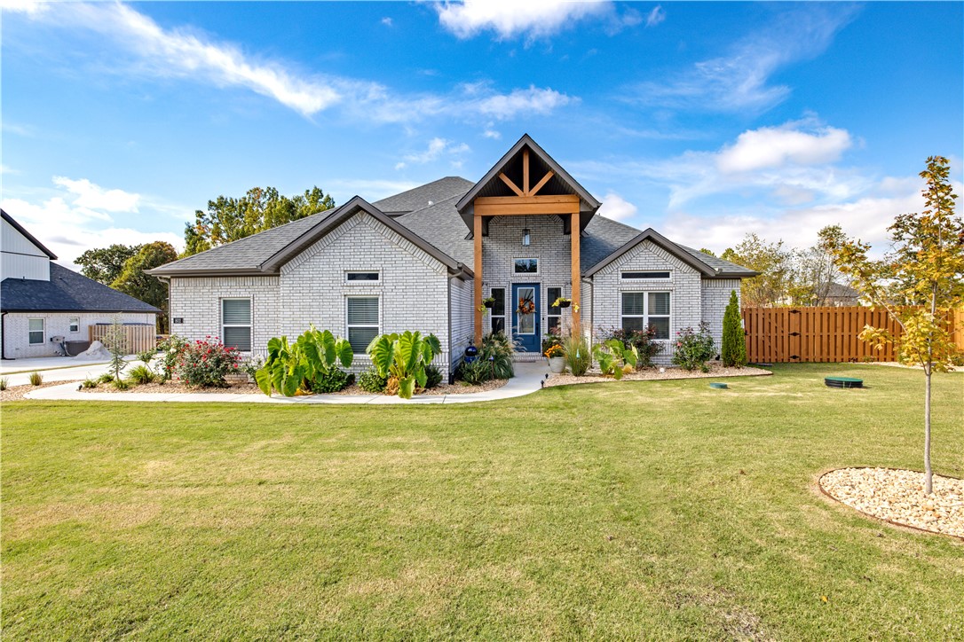 Gorgeous Home sitting on over .50 acre with many upgrades. This spacious 4 bedroom 3 1/2 bath home boast soaring ceilings with large windows providing lots of natural light. Main floor features an open concept living & kitchen space, master bedroom & bath and an additional bedroom with a full bathroom and oversized walk in closet. Gourmet kitchen with double ovens, gas range, built in microwave and granite counter tops. Upstairs is a bonus room with a mini kitchen plus 2 additional bedrooms and a full bathroom. Large flat backyard and a covered patio with fireplace. Seller recently extended the concrete patio, added an outdoor kitchen, fully fenced backyard, concrete pad for storage shed & new sprinkler system plus additional landscaping.