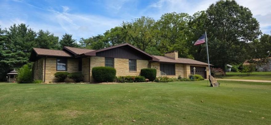 Spacious and beautifully maintained 3BR 3.5 BA home offering over 4,000 sq. ft. Of living space with a new roof on both home & detached garage/shop.  This property combines classic charm with modern updates and provides plenty of room for family, entertaining, and hobbies. This unique property offers flexibility with multiple living areas and two sunrooms overlooking a beautiful backyard with garden spot and gazebo.   The detached garage/workshop provides an ideal space for vehicles or a multitude of projects.  Enjoy the fireplace both upstairs & downstairs.  This home has an abundance of storage.  Home also features a formal dining room and breakfast nook in kitchen.  Custom cabinets and hardwood floors in most of the home round out this well maintained home that is located on 30 minutes from Branson Missouri and is only 30 minutes from two beautiful lakes or the Buffalo National River.