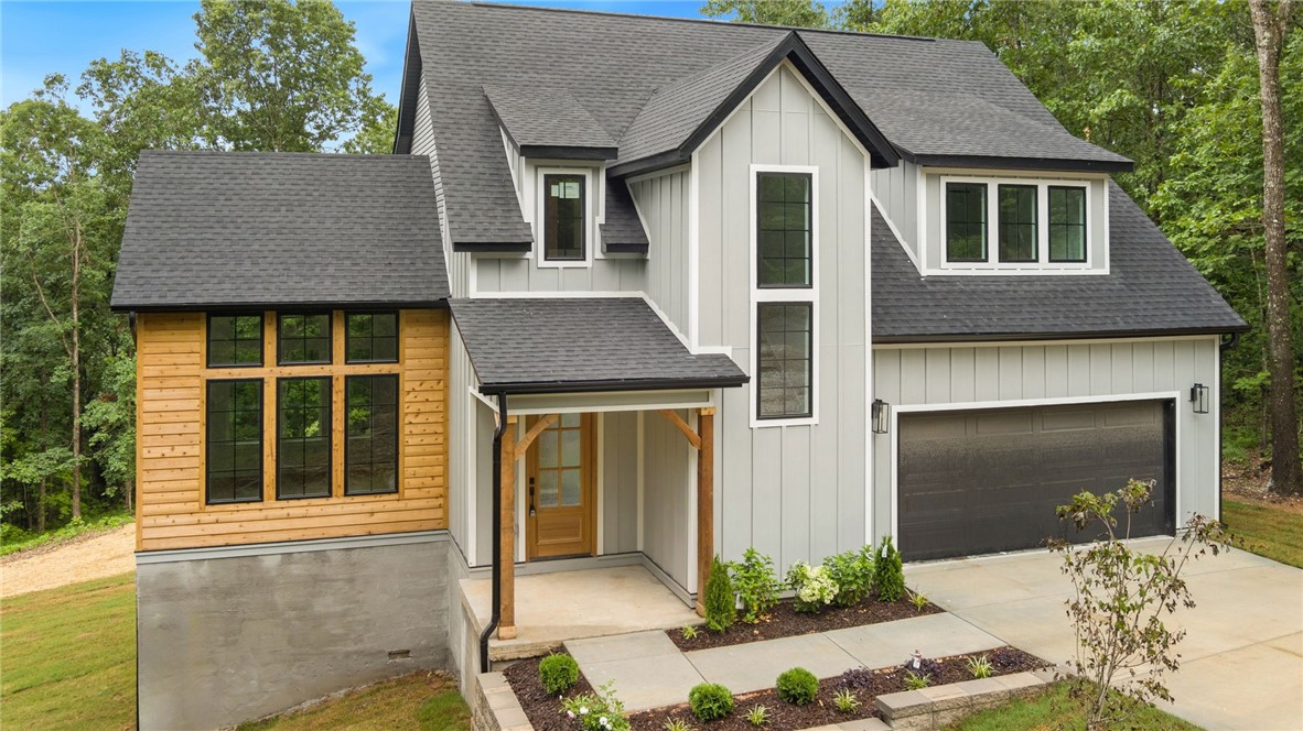 This stunning two-story 3 bed home with Office is located in the peaceful Bella Vista area, offering privacy, stunning views, and backyard access to the Back 40 bike trails from a huge gently sloped cul de sac lot without neighbors. Situated on a prime lot with mature hardwood trees, this home blends modern design with natural beauty. Inside, gorgeous oak hardwood floors lead you to the spacious main level, featuring a primary bedroom with a luxurious ensuite bath, dual vanities, soaking tub, and separate shower. The walk-in closet includes its own washer and dryer connections for added convenience. The home also boasts a gorgeous covered back deck, perfect for relaxing and entertaining. Upstairs, you’ll find two guest bedrooms, a full bath, and a second laundry room. A spacious office and loft area offer flexible space for work or play. With convenient access to I-49 and Bentonville, this home combines style, functionality, and a prime location. Don’t miss your chance to make it yours!