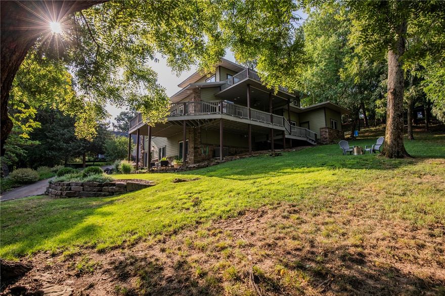 Tucked away on Fayetteville's desired Mt. Sequoyah, this beautiful "house in the trees" offers exceptional views of all of NWA! Featured in At Home Arkansas for its eco-friendly design, this stunning 3 level home is a reflection of its natural surroundings. Natural elements were used in every detail: walnut posts sourced from the property on display in the living room, locally-milled cherry cabinets, & hickory & natural stone floors. The triple-pane, vinyl clad windows offer breathtaking sunset views. In addition to the 3 bedrooms, there is a built-in office space, basement flex space with wet bar area, and multi-use room adjacent to the primary bedroom. The primary suite boasts a clawfoot tub, walk-in shower, and multiple skylights. Maximizing space, one of the downstairs bedrooms has a built-in Murphy bed and sliding barn doors. You'll appreciate the natural elements of the professional landscaping with accent boulders, stone steps & mature, native plants. Located just 1.5 miles to Dickson St & U of A. HVAC 2019.