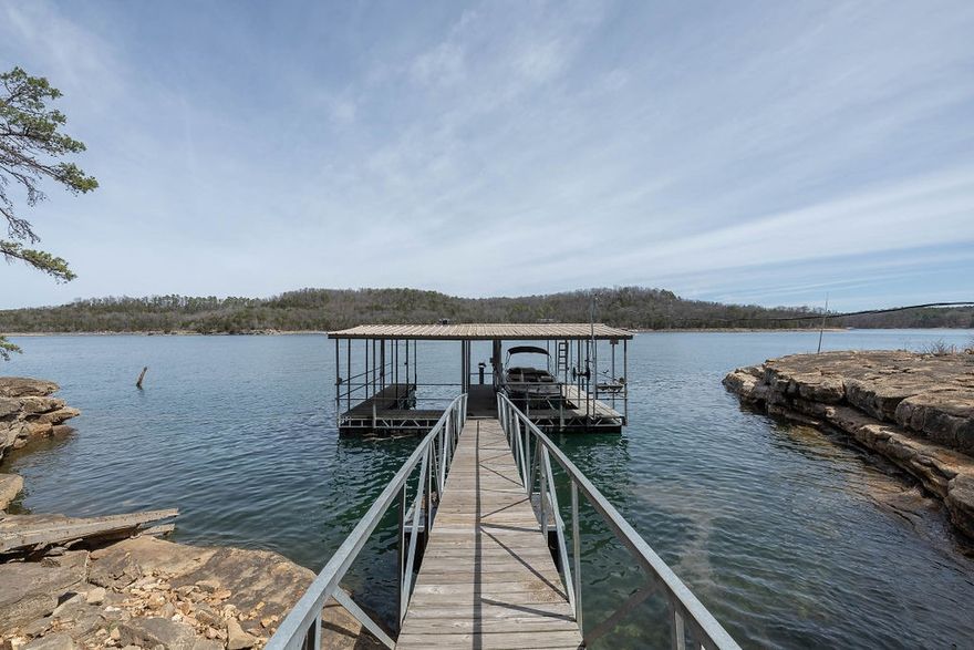 Stunning Lakefront Retreat
Key Features
·       Prime Lakefront Location: Wake up to breathtaking views and enjoy direct access to the water from your very own front yard.
·       Two Private Boat Slips: Effortlessly explore the lake with two private slips, one with a lift, providing easy access for your watercraft and endless boating adventures.
·       Expansive Deck: Perfect for entertaining or soaking in the natural beauty, the large deck offers ample space for outdoor gatherings, sunbathing, or stargazing.
·       Screened-In Porch: Enjoy the outdoors all year round in a spacious, screened-in porch that keeps the bugs at bay while providing a cozy spot to relax with a book or a cup of coffee.
This property is a rare gem for those seeking an idyllic lakeside lifestyle. Whether you're entertaining guests, embarking on lake adventures, or simply unwinding in peaceful surroundings, this retreat has everything you need to create lasting memories. Don’t miss the chance to make this dream home your reality!