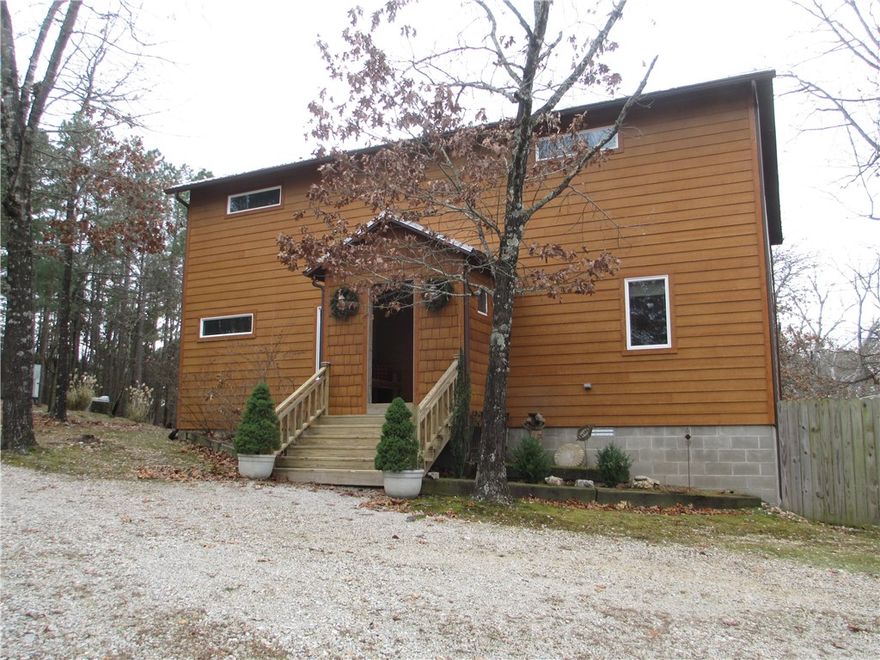 Custom built one owner home sitting on 4+ acres has been lovingly maintained and is now available!  Come see this modern style home that is filled with natural light throughout.  Upon entry you are taken aback by the shear scope of the openness and one of a kind design. The 20 foot ceilings promotes the grandiose feeling this home encompasses. Oversize guest bedroom on main level provides plenty of space for relaxing, while keeping you close to the action in the heart of the home. Grand living room is warmed by the fireplace & offers views of the back deck & surrounding woods.  Kitchen with it's gleaming stainless steel backsplash has all the expected amenities & more. Traverse the open stair case that leads to the private owners quarters of the upper level where you will experience a one of a kind walk thru shower room and take in views of the lower level. Your options for being one with nature  is satisfied by lounging in the 5' deep pool, partaking of beverages at the tiki bar or exploring the grounds!