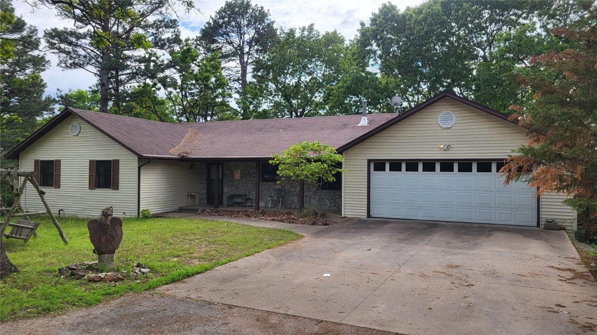 Your chance to own a Eureka Springs gem of a property! This large home sits on a quiet, dead-end street behind the Eureka school zone, just minutes from the main town, yet out of the city limits. The two covered decks look out over the fenced-in backyard and over the wooded property behind which drops off to Lucerne Road. A well-lit, partially finished walk-out basement opens onto a third deck. The basement sports studio lighting (was used as an art studio), and contains the 4th bedroom with ensuite bath and kitchenette and has a wood-burning stove. A large separate workshop/storage area/cellar is under the garage. The three main bedrooms and two baths are on the main level alongside the living, dining, kitchen with eat-in area, and laundry. The extra-wide 2 car garage opens onto a concrete driveway. The house is well-engineered, is in great shape and includes a vast amount of storage area. Updates may be desired in wall-coverings, flooring, and wet areas. Priced to sell as-is. Interior photos on the way.