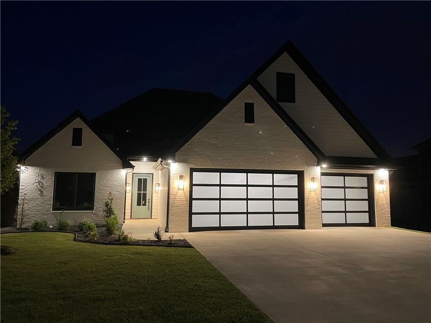 Truly a gem in west Bentonville, just 3.5 miles to the Square. Beautiful new construction with spacious,
open floor plan. Wired for sound. Gourmet kitchen with commercial grade appliances including 60" fridge/freezer. Large granite island, plenty of counter space, and walk-in pantry storage. Master suite with custom wood detailing, tiled shower, soaking tub, and a big walk in closet connected to laundry/mudroom. Second bedroom and full bath also on main level. Upstairs features bedrooms three and four with walk in closets, two full baths, and large bonus room (could be 5th bedroom). Three car garage, water heater with recirculating pump, full yard sprinkler, covered back porch, and will include backyard horizontal cedar privacy fence with caps!