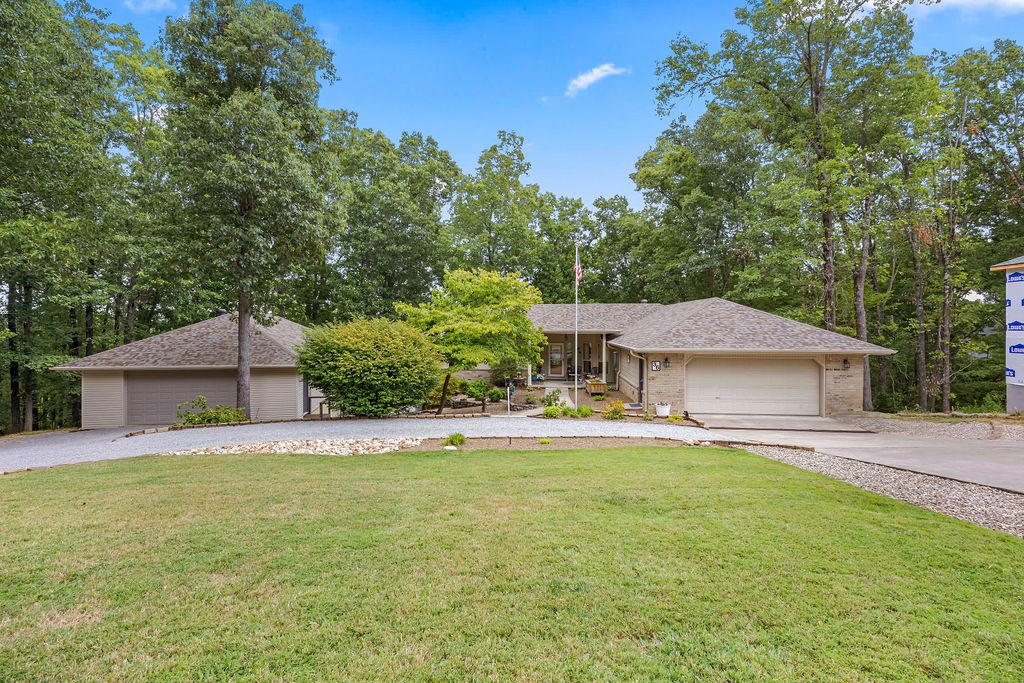 Gorgeous home located close to Lake Avalon, sitting on two lots that total nearly an acre (.90), and offering a seasonal peek a boo lake view with a peaceful setting. The property features a circle driveway with additional parking & a finished lower-level bonus room for extra living space. Inside, youāll find hardwood floors throughout, a sunroom with newer Anderson windows, & a layout that provides both comfort and flexibility. The roof was replaced in 2023, the home is already connected to sewer. The detached two car garage (approx. 28āx 29ā) is a standout feature, offering its own 200-amp service plus a separate heat & air unit. Attached to the garage is an impressive heated & cooled ADU/shop (approx. 20āx 29ā). The home also includes a finished lower-level room (approx. 369 sq. ft.), giving you plenty of options for a home office, hobby area, or guest suite. Located down the street from the Lago Vista bike trail, this property combines functionality, space, & prime location near the lake a true Bella Vista gem.