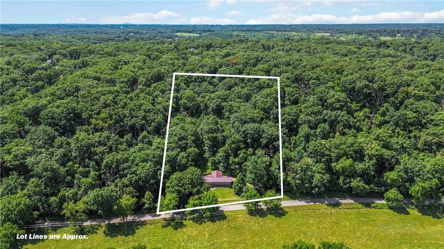 Location, Location, Location - BEST OF BOTH WORLDS - in county, outside of city limits with lush trees, hills, and starry nights of Northwest Arkansas! Just 5 minutes from I-49, 11 minutes from Downtown Bentonville, and 14 minutes from Walmart HQ. Less than 2 miles from the new OZ Trails System park with a gondola that is planned just west of 71B. This +/- 2,667 SF home on +/- 3.3 acres offers 4beds (3 on the main floor, 1 in the basement), 2.5 baths, and a 2-car garage. Recent upgrades include brand new granite countertops, dishwasher, wood floors throughout, garage doors and motors, and pipe fencing around the home with two gates. Features include a cozy living room fireplace, breakfast nook, walk-in closet in the primary, and a finished basement with a game room. Outdoor living includes wooded surroundings, fenced yard, covered patio, and 2 storage sheds. Located within the desirable Bentonville School District, this property combines country charm with city convenience.