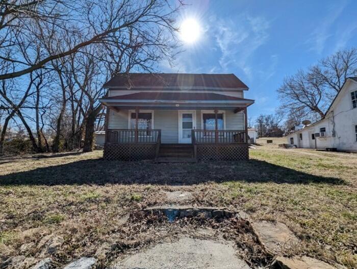 3 bedroom 1 bath fixer upper located on Main St. in Alpena with a ton of commercial potential and a high traffic count on Hwy. 62/ Hwy. 412. Great location for a business with endless possibilities. Selling as-is, all #s are approx, sq. footage per assessor, buyer to verify existence of septic.