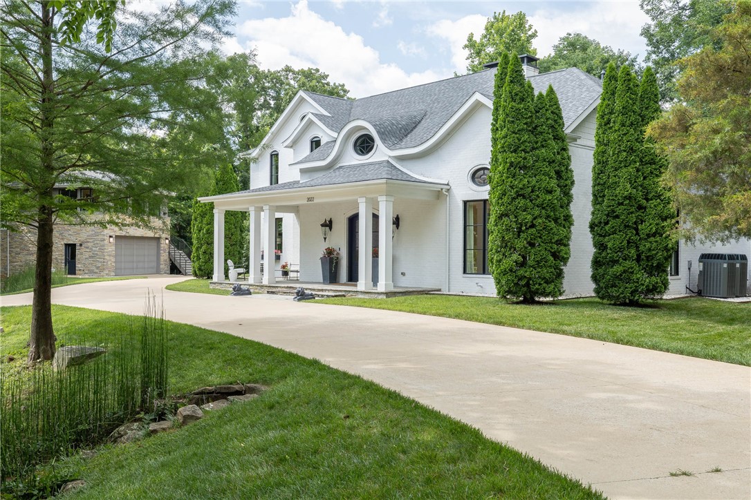 First time on the market! This custom-built Modern European estate just steps from the University of Arkansas blends timeless elegance with contemporary design. Thoughtfully crafted with steel, glass, and concrete for a seamless indoor-outdoor lifestyle. The limewash brick exterior with stacked stone, accented by a stone bridge circular drive, sets a stunning tone. Inside, the main living area is an entertainerās dreamāopen concept with a wine bar built from 1871 Chicago fire brick and reclaimed wood. The garage doubles as a luxe flex space with porcelain tile flooring, a ceiling-mounted projector, and a glass door that opens to a spectacular backyard featuring a full outdoor kitchen, built-in seating with custom cushions, concrete entertaining pods, and a hot tub. A detached oversized garage offers boat storage plus a full apartment aboveāperfect for guests or extended stays. Rare opportunity to own a functional estate in one of Fayettevilleās most desirable locations! Guest house not included in sq ft.