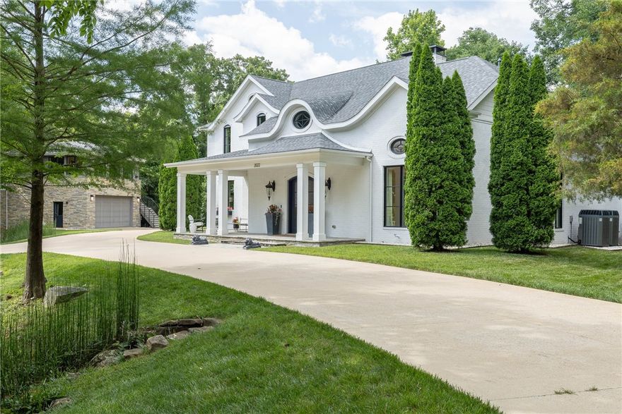 First time on the market! This custom-built Modern European estate just steps from the University of Arkansas blends timeless elegance with contemporary design. Thoughtfully crafted with steel, glass, and concrete for a seamless indoor-outdoor lifestyle. The limewash brick exterior with stacked stone, accented by a stone bridge circular drive, sets a stunning tone. Inside, the main living area is an entertainer’s dream—open concept with a wine bar built from 1871 Chicago fire brick and reclaimed wood. The garage doubles as a luxe flex space with porcelain tile flooring, a ceiling-mounted projector, and a glass door that opens to a spectacular backyard featuring a full outdoor kitchen, built-in seating with custom cushions, concrete entertaining pods, and a hot tub. A detached oversized garage offers boat storage plus a full apartment above—perfect for guests or extended stays. Rare opportunity to own a functional estate in one of Fayetteville’s most desirable locations! Guest house not included in sq ft.