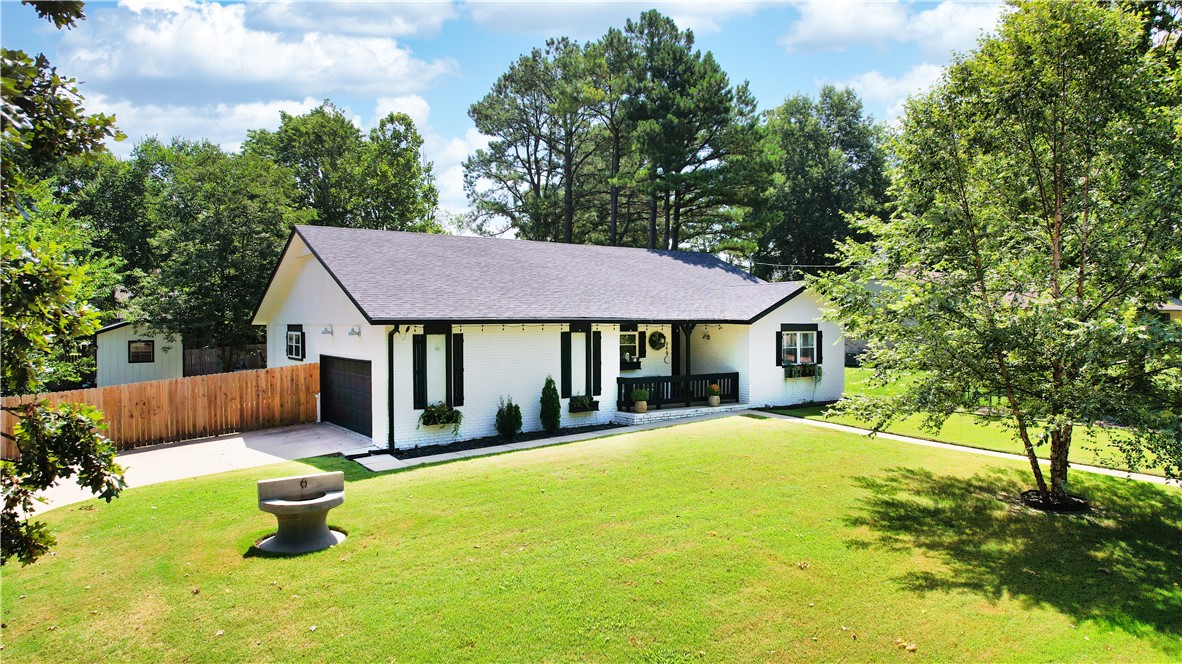 Want to live close to downtown Bentonville? Your wait is over! Check out this updated home with amazing outdoor living area, complete with Gunite pool! You will love the location, less than 1 mile to the square, right next to Park Springs Park, Black Apple Creek trail, easy access to all that Bentonville and NWA has to offer! Plus, new roof (2022), new HVAC (2021), pool (2021), and many other upgrades including new windows (2018)! Home has 4 bedrooms and 3 full baths to include 2 Primary suites, an open living area, nice dining area, side load garage and covered front porch.