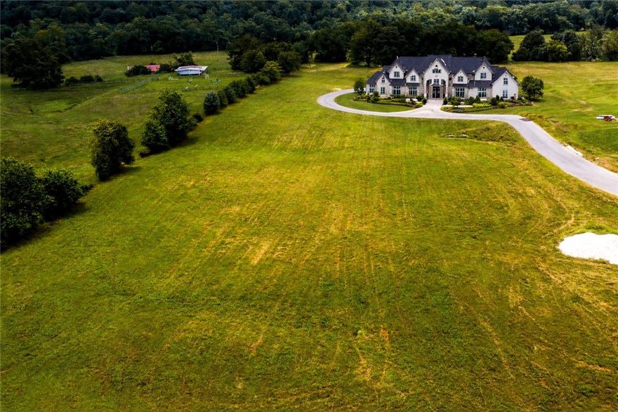 Are you dreaming of living in a community with a neighborhood feel but also have some space? Build your dream home on this premier estate lot located in one of NWA's most coveted areas. This exceptional lot offers the ultimate in luxury, privacy, and convenience. Located on a private, gated drive only 3 min from 112, 6 min from I-49, and 7 min to 412, this lots offers easy access to major routes, making commuting a breeze while still providing a peaceful retreat from the hustle and bustle. Nestled in a distinguished area known for its beauty and luxury homes, this location is just 5 minutes from the Blessings Golf Club and backs up to Clear Creek. This 4.45 acre lot allows for ample space while enjoying the benefits of a family-friendly neighborhood. Additional acreage available. *House is for inspiration purposes only.