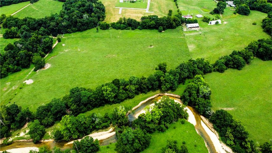 Are you dreaming of living in a community with a neighborhood feel but also have some space? Build your dream home on this premier estate lot located in one of NWA's most coveted areas. This exceptional lot offers the ultimate in luxury, privacy, and convenience. Located on a private, gated drive only 3 min from 112, 6 min from I-49, and 7 min to 412, this lots offers easy access to major routes, making commuting a breeze while still providing a peaceful retreat from the hustle and bustle. Nestled in a distinguished area known for its beauty and luxury homes, this location is just 5 minutes from the Blessings Golf Club. This 4.45 acre lot allows for ample space while enjoying the benefits of a family-friendly neighborhood. This location has been perc tested for a 5 bedroom home and is equipped with water, electric, & natural gas. (The house next door at 573 Reed Valley will undergo a complete remodel in October).
