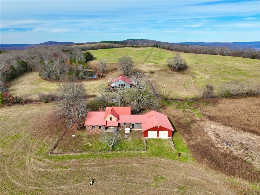 Mountain top farm and adjoining hunting tract in the Boston Mountains, bordered by the Ozark National Forest. Features a 4-bed, 2-bath farmhouse, shop, barn, stocked pond, pasture, hardwood timber, game pond, and panoramic views. Deer, bear, and turkey are abundant with numerous stand sites. Offers privacy, seclusion, and excellent investment potential. Home sold AS IS; 24-hour notice required.
