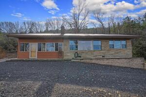 This home gives you access to 1000's of acres of National Forest & is a must see! 1 bedroom, 1 bathroom home including a basement, 32' x 12' fully furnished cabin & 32' x 30' insulated shop with a 32' x 16' lean-to. All located less than 10 minutes east of downtown Danville, Arkansas. Situated on 4.70 acres, this hunter's paradise sits snug in the valley between the Ozark & Ouachita Mountains and is just a short drive from Highway 7 to enjoy hunting, fishing, hiking & more. This home offers 1,656 square feet of living space, including a sensible kitchen to fry up deer meat, a bright bonus room to enjoy morning coffee & a master suite with tons of natural light. Also, a covered rock patio & a gas fireplace in the living room to help keep you warm during the winter. Set up a showing today!