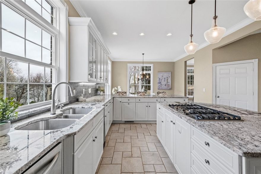 Welcome to this stunning lake home with beautiful Beaver Lake views and a coveted boat slip in the community dock right across the street! As you enter the home you are greeted with a grand foyer with large 2 story windows that let in incredible natural light. The kitchen is large and updated with granite countertops and appliances. The main floor features the primary bedroom, office, formal dining, formal living, kitchen, eat-in kitchen, and informal living room. Upstairs features 2 large bedrooms with en-suites, a large media room, a large bonus room/bedroom, and an additional full bathroom. The walk-out basement features 2 more large bedrooms with en-suites, a laundry room, and a game room. Sip your cup of coffee and enjoy the view on the large back deck. Only minutes from Prairie Creek Marina and downtown Rogers. Come and see why "Life Is Better at the Lake." Boat slip for serenity: 10'x30' bay 3 of a 6 slip community dock.