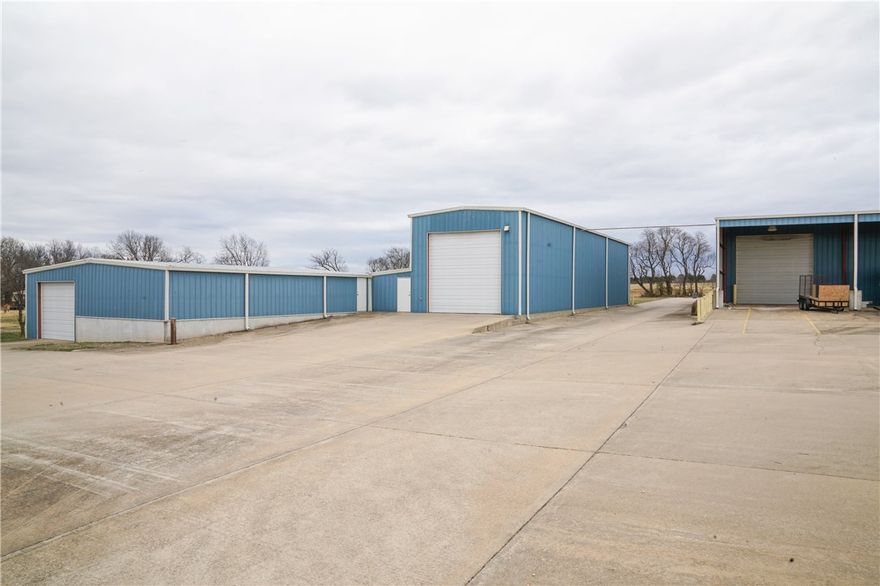 Best buy just outside the Lowell city limits.  Manufacturing or warehouse facility that has it all; 5000sf office, 15000sf manufacturing floor or maintenance/warehouse space, 2000sf service/wash bay, 1500sf shop, and 2000sf brick home (as is).  Perfect setup & location for a trucking business. Incredible amount of concrete parking & room to expand. It is situated just a mile from the Highway 265 expansion.  This property has an incredible amount of features for the price.  Use part & lease out the rest.