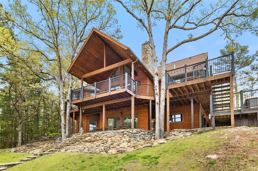 Luxury lake front living with year round views of Beaver Lake on 7.15 acres. This custom designed 5 bed/3.5 bath home was built for hosting with multiple living spaces, eating areas, game room, ample parking and multi-level deck with built-in hot tub. Access your private two-slip dock via a flagstone stairway or ATV path. Don't forget the oversized detached garage with workshop area for additional parking and all of your hobby/storage needs. This is more than just a home; it's a rare opportunity to own a piece of paradise where every day feels like a vacation! 

Boat dock w/ lifts measures 31ft x 40ft. Extensive interior update - oak hardwood floors, trim, and paint - 2020. Cedar siding/deck staining, driveway resealed - 2022. Leaf Filter guards added - 2022. Home generator and Ozone water treatment system. New Culligan water softener and RO water filter - 2022. Fully owned solar system - 2022. Air Scrubber - 2023. New exterior doors and south-facing windows - 2023. Septic pumped and extended - 2023. Agent Owned.