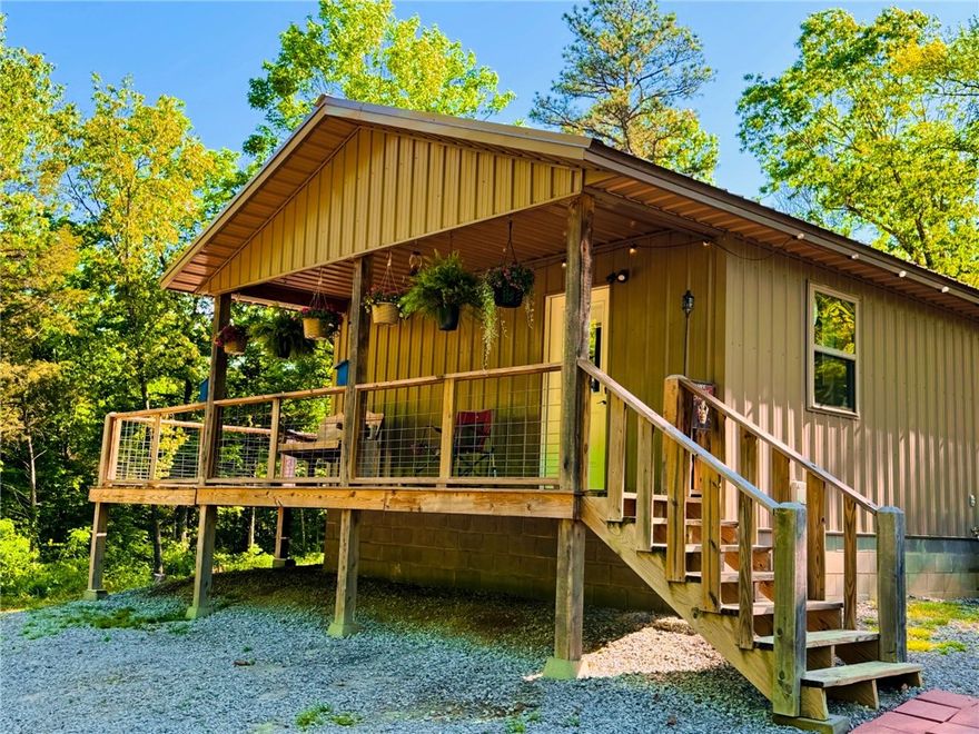 Discover 28 acres of prime Ozark landscape featuring a 1-bedroom, 1-bath cabin with a wraparound porch and inviting country charm. A spring-fed, stocked pond with a scenic waterfall sits just below the cabin, offering a peaceful setting for fishing and relaxation. The property is rich with wildlife, including whitetail deer, black bear, and seasonal elk, making it ideal for hunting or nature enthusiasts. Conveniently located near Wilderness Riders Buffalo Ranch, Outskirts of Heaven RV Park, and Heaven’s Door Cabins, this property offers strong potential as a private retreat or investment opportunity. Just minutes from Boxley Valley and the Buffalo National River.   Elk and bear frequent the property.  Access by deeded easement.  Property currently on shared well with permission to connect to rural water.