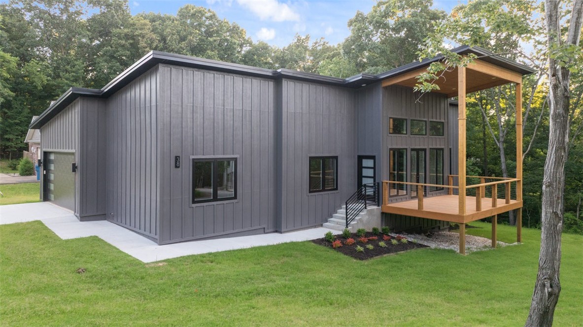 Modern home located on a corner lot. No expense has been spared on building this top-of-the-line home nested in the woods. Came and see the following:
-Many extra large, high-end, German style tilt-turn aluminum windows. Extra large and upper windows let in plenty of light. Tilt windows have specialized mechanism to allow ventilation in easily without full opening of windows.
-Extra heavy duty metal roof. You will not need to worry about replacing this roof for many decades. In fact, it may very well outlive its owners. These types of roofs can last up to a century with minimal maintenance.
-Single slope roof for a modern look and feel
-Sloped-roof in the main room up to your window wall for taking in the Bella Vista forests and natural light.
-Beautiful oak beams in the main living area
-Lovely front porch with double-tensioned cable railing for added strength
-Additional 14'x14' concrete storage room beneath the house
-Full fiber cement exterior (Hardie)
-Hardwood floors
-Designer showers