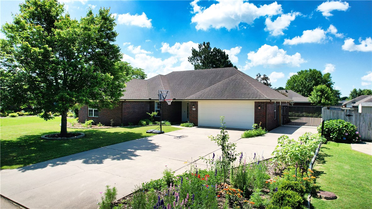Move-in ready and full of upgrades! This beautifully updated home features an open floor plan with new hardwood flooring, ceramic tile in wet areas, and fresh paint inside and out. The kitchen includes a stainless farmhouse sink, ample storage, pantry, and updated lighting. Relax in the spacious primary suite with dual vanities, dual closets, walk-in shower, and soaking tub. Enjoy the covered patio overlooking a lush, landscaped yard shaded by mature trees. Bonus features include a deep garage (great for storage or a workshop) and an RV pad with electric and sewer hookups. Located near top-rated schools, shopping, I-49, Razorback Greenway, and JB Hunt HQ. Donāt miss this great valueāschedule your private tour today!