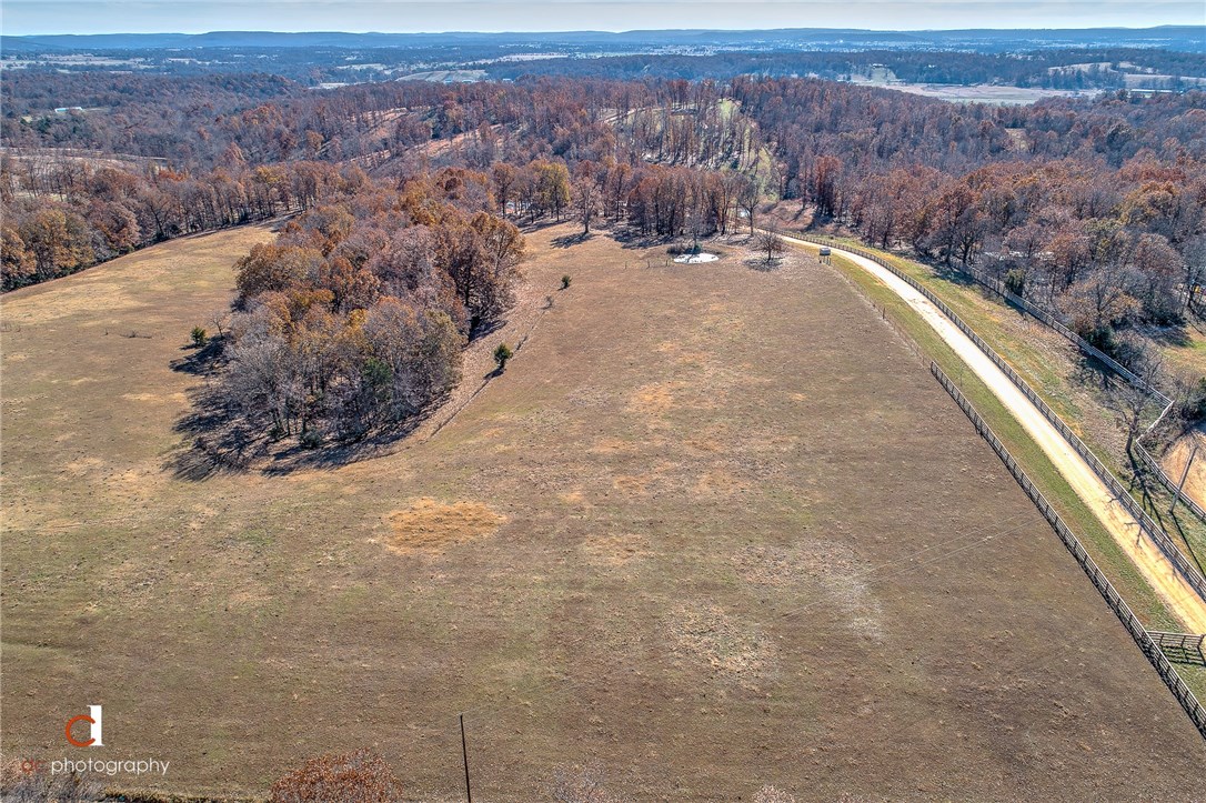 Beautiful 10+/- Acres located in West Fayetteville. Located on the East Side of Draper Rd. contains Ponds and plenty of open pasture. Property is fully fenced and cross-fenced. Water, Electric, and Internet at street. School of choice to be Prairie Grove or Farmington. Livestock in both fields and will get out. Listing agent must be present to gain access to property.