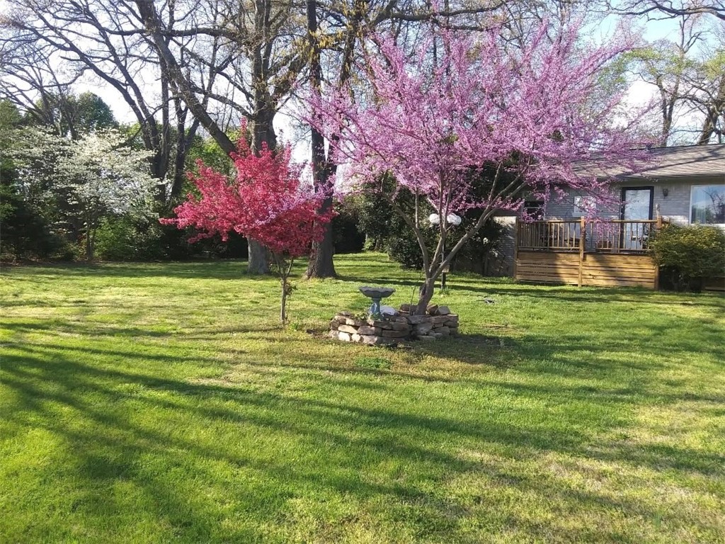 Slice of heaven, nestled amongst beautiful trees, lined on street with huge lots. Country/peaceful feel, but almost walking distance to Promenade. Open floor plan, added sunroom for office/workout/mudroom. Lots of natural light. Beautiful front deck to watch the sunsets, huge backyard for anything. Plenty of room to expand the house on the lot. Oversized 2 car detached garage is an excellent workshop. Long sprawling driveway, you will love the feel of this property. Roof was replaced in 2020.