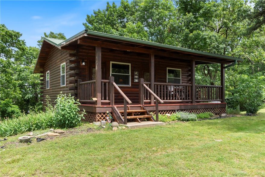 This charming cabin is a Successful AirBNB rental offering three bedrooms and 1.5 baths, with the third bedroom currently used for storage. Rich in rustic character, the home has been thoughtfully updated with quartz bathroom countertops, new shower/tub, 2” blinds, a fenced backyard, gutter guards, RV hook-up, and a new washer and dryer. The well has been recently serviced, adding peace of mind for the next owner.

Also included is the historic Concord Schoolhouse — a true piece of local history. This original one-room schoolhouse features a new roof and was once used as a wedding venue. With its character and charm, it’s ready for restoration as an event space, studio, or something entirely your own.

With no restrictions and being sold fully furnished — right down to the dishes — this property offers endless possibilities: continue the successful Airbnb, host events, create a unique venue, or simply enjoy it as a private getaway near the river.