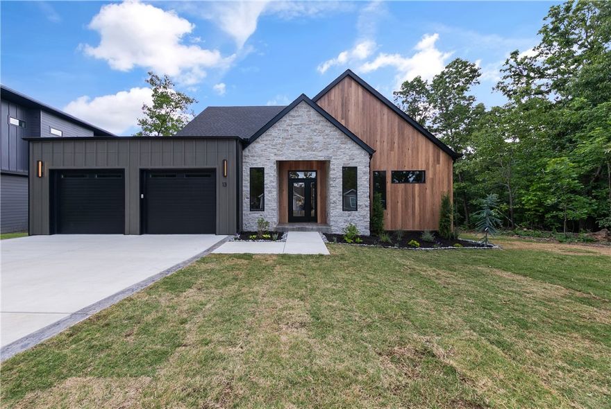 A custom home without the wait, hassle, or unexpected expense! Perfectly positioned near the Tunnel Vision mountain bike trail, this stunning new construction offers the ideal blend of modern design, warmth, and functionality — all in a location that lets you enjoy the NW Arkansas lifestyle right outside your door. Sunshine pours through the stylish black windows, filling the home with natural light and highlighting the clean architectural lines and carefully curated finishes throughout. Thoughtfully designed to feel both elevated and inviting, this home truly must be seen in person to be fully appreciated. Whether you're an avid cyclist, nature lover, or simply looking for a beautifully crafted home in an unbeatable location, this one delivers luxury features - without the stress of building from scratch.  Home Features: 3 bdrm, 2 baths,custom cabinetry,real hardwood floors throughout,ceiling beams,illuminated mirrors & many other designer details(Septic permit for 2 bdrm)