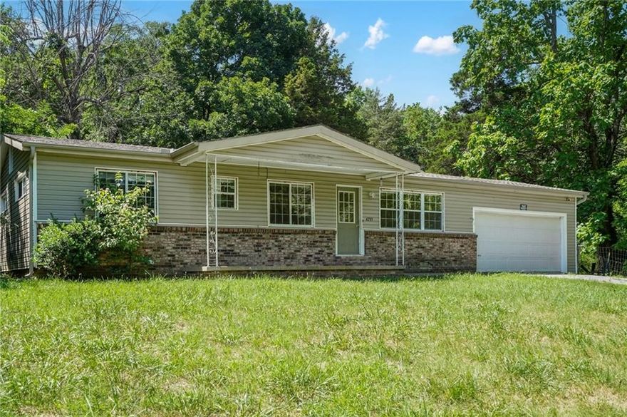 Welcome to this charming 3-bedroom, 1.5-bathroom home located in the lively city of Fayetteville, AR. This property boasts an open floor plan, allowing for a seamless flow between living spaces. The home features beautiful wood floors throughout, adding a touch of elegance and warmth. The kitchen comes fully equipped with all necessary appliances, ready for your culinary adventures. The home also includes a spacious 2-car garage, providing ample storage and parking space. One of the standout features of this property is the large back deck, perfect for outdoor entertaining or simply enjoying the surrounding greenery. The home is situated on an extra-large lot, offering over an acre of private green space for your enjoyment. This property offers a unique blend of privacy and openness, making it a perfect place to call home.