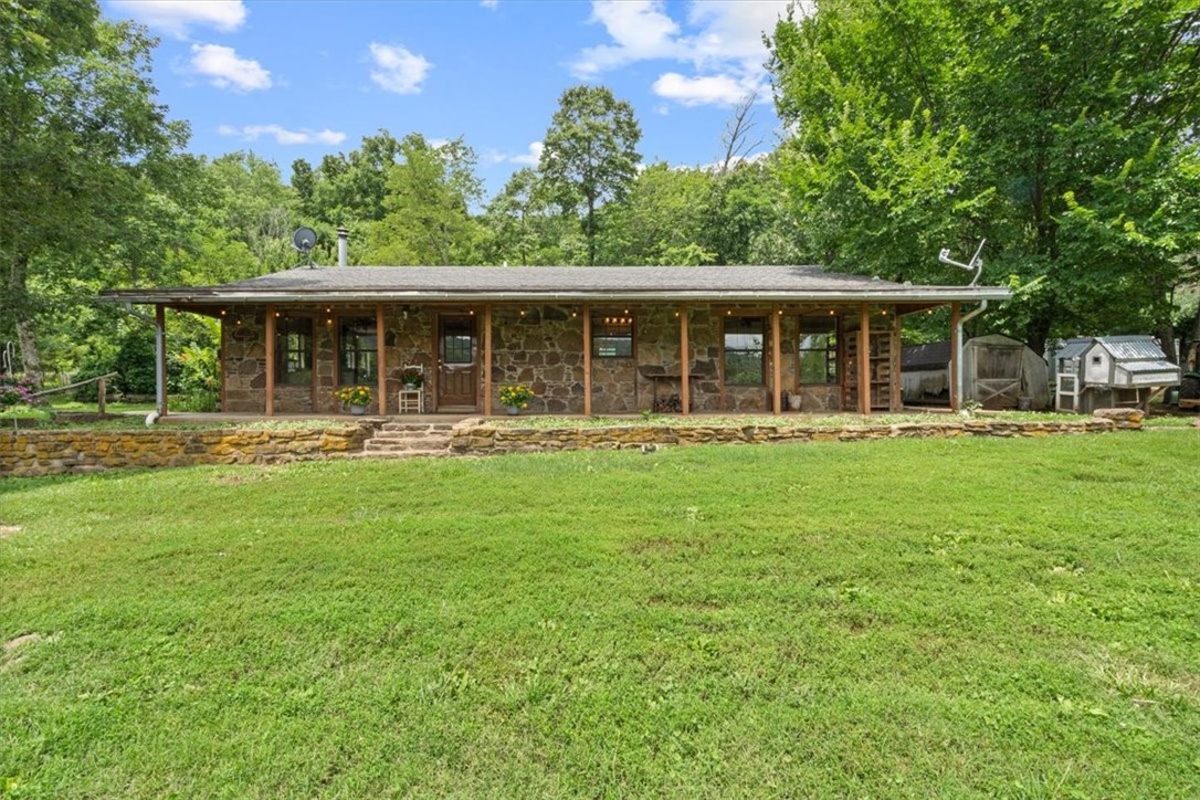 Beautiful Ozark home and farm life awaits you. This 76 acre property features a 3 bedroom and 2 bath home featuring 2,252 sq.ft of interior living space with split plan and many unique amenities. With approximately 12 acres cleared for pasture and gardening, you can be self sufficient here without any problem. The home runs on clear well water and a spring to back it up. The pole barns, sheds and chicken coops can house and maintain your livestock. You can spend your fall chasing the healthy deer, turkey, and bear population that call the area home too. This is rural living at its finest.
