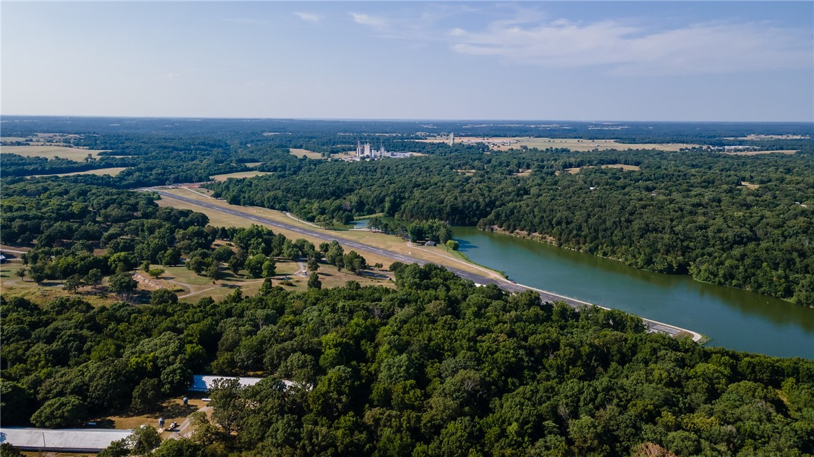Seize the opportunity to own a one-of-a-kind property in Arkansas, where business meets nature and lifestyle meets luxury. The previously owned Peterson Farms property is for sale. This expansive 230-acre property offers unparalleled potential with a private airport featuring a 3/4-mile-long paved runway, five fuel tanks, and 18000 sq ft of hangar storage. Perfect for aviation enthusiasts, business owners, or developers, the property’s prime location provides direct access to two major highways, ensuring convenience for transportation and logistics. Additionally this unique estate offers stunning lakefront views, creating an idyllic setting for both business and recreational use. Whether you're looking to expand your aviation business, build a custom retreat, develop a mixed-use commercial venture, or develop an exclusive air-park residential community this versatile property offers endless possibilities. Three existing homes on the property offer a base level of what could be the most exclusive neighborhood in NWA