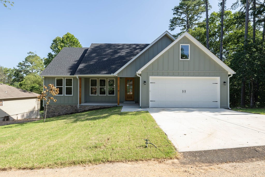 Experience the inviting appeal of this new construction single-story ranch-style home, perfect for those who love to entertain. The open-concept kitchen is thoughtfully designed with sleek countertops, a generous center island, gas range and abundant cabinetry for all your storage needs. The primary suite is a peaceful retreat, featuring a bright and stylish en-suite bathroom with granite counters, walk-in glass shower, a luxurious freestanding soaker tub, and an oversized walk-in closet- all tucked behind French doors. Convenience meets function in the mudroom, complete with built-in seating, hooks, shelves and cubbies; offering organization once you enter off the garage. The laundry room, located separately off the garage, adds even more storage and utility. Unwind on the covered back porch-ideal for sipping morning coffee or stargazing in the evening. This home offers the perfect blend of contemporary comfort and serene surroundings, delivering a well-crafted space that feels like a true escape.