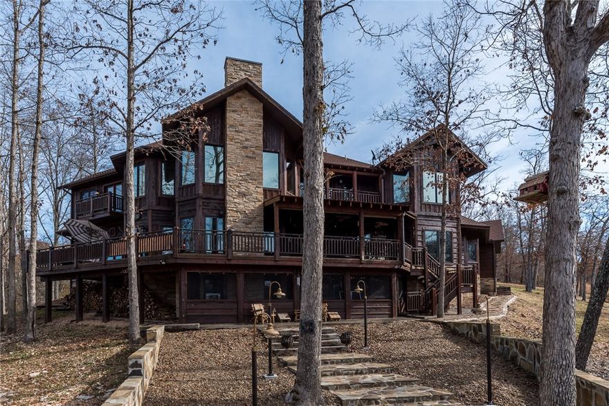 One of a kind Beaver Lake Cedar Lodge!  Perched atop a hillside with a mesmerizing view, this rustic but elegant lodge home has everything you have been dreaming of for lakefront living!  Surrounded by natural beauty, this home is on 3 acres and comes with hard to find 4 stall-boat dock.   Home is 3 levels, 1200 sfoot of wrap around decks, fire pit, multiple outdoor living areas.  Two-story Living Room with massive floor to ceiling stone fireplace and rustic beam work.   Master Suite with two-story rustic beam accents and loft area.    Entertain in style with the basement rec area complete with bar, pool table and TV area.   Adjoining .63 acre can also be purchased with property.  Truly a one of a kind property!!  Complete list of amenities and upgrades attached.