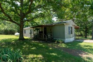 Beautiful, secluded park like setting with large trees surrounds this well maintained home. Covered front and back porches. Covered parking the back. Shop building with concrete floors and rock fireplace. Also has a small garden shed with plenty of shelves. Year long pond a short walk from the house.
