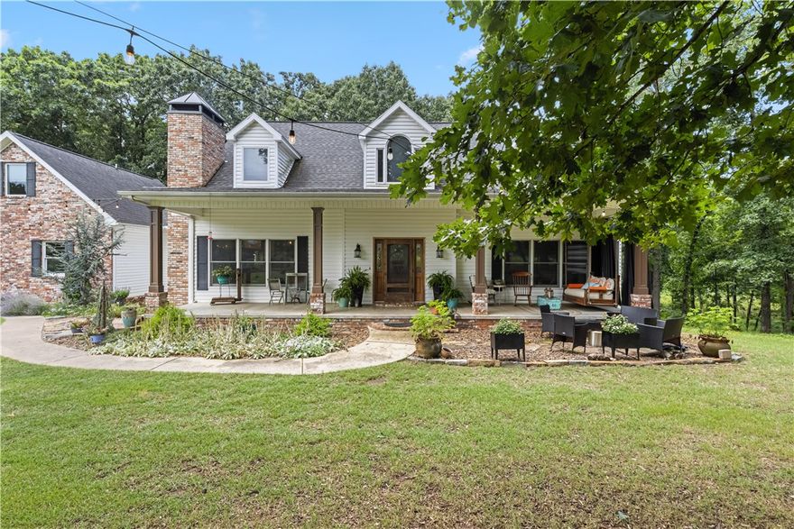 A nature lover’s dream—just minutes from everything! This unique home sits on a peaceful slice of paradise, just a few minutes from Downtown Bentonville, Rogers, Pea Ridge, and the new Walmart Home Office. Enjoy morning coffee on the front porch or new back deck while surrounded by hummingbirds, songbirds, deer, and more. 
The fenced garden includes asparagus, blackberries, blueberries, a fig tree, and fresh landscaping.
Inside, the open floor plan radiates warmth and comfort. The kitchen is a chef’s dream with a wood-fired pizza oven, refurbished 1936 stove, two dishwashers, a drawer fridge, and a butler’s pantry. Large windows in the living room look out to the woods. The main level features the master suite and a cozy den. Upstairs, two identical bedrooms each have private baths.
Above the two-car garage is a bonus room with its own bath and a garden-view desk. A shop, RV barn, and chicken coop complete this beautifully eclectic farmhouse.
The is a 5 acre adjoining tract that is also for sale. MLS 1315200