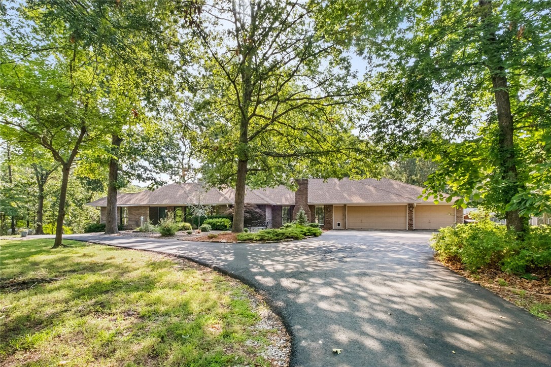 This lovely 4,803 sq ft home offers a new way of country living yet so close to town with all the wildlife. Unbeatable proximity to the vibrant Downtown Bentonville area & the Coler Mountain Biking trails just down the hill. Situated in N Bentonville on 2.79 acres, enjoy all AR's beautiful seasons with a variety of space & rooms for all your indoor & outdoor gatherings, or simply to tinker. The 3 bed 3.5 bath home lends several bonus rooms which could easily be converted to a 5 beds total. Take your pick from the sun porch, screened in deck, or a covered deck. A few features: chef's delight w a massive kitchen island, hickory cabinets galore, quartz counters, 2 propane fireplaces (previously wood burning), hard surface flooring throughout, certified storm shelter, 2 utility rooms, storage throughout, stand-by backup generator, 3 car garage, & a 40x30 metal building w own septic. Don't miss out-it's time to create your own lifestyle at 11892 Walnut Lane. Subdivision does allow some livestock. Bentonville Schools.