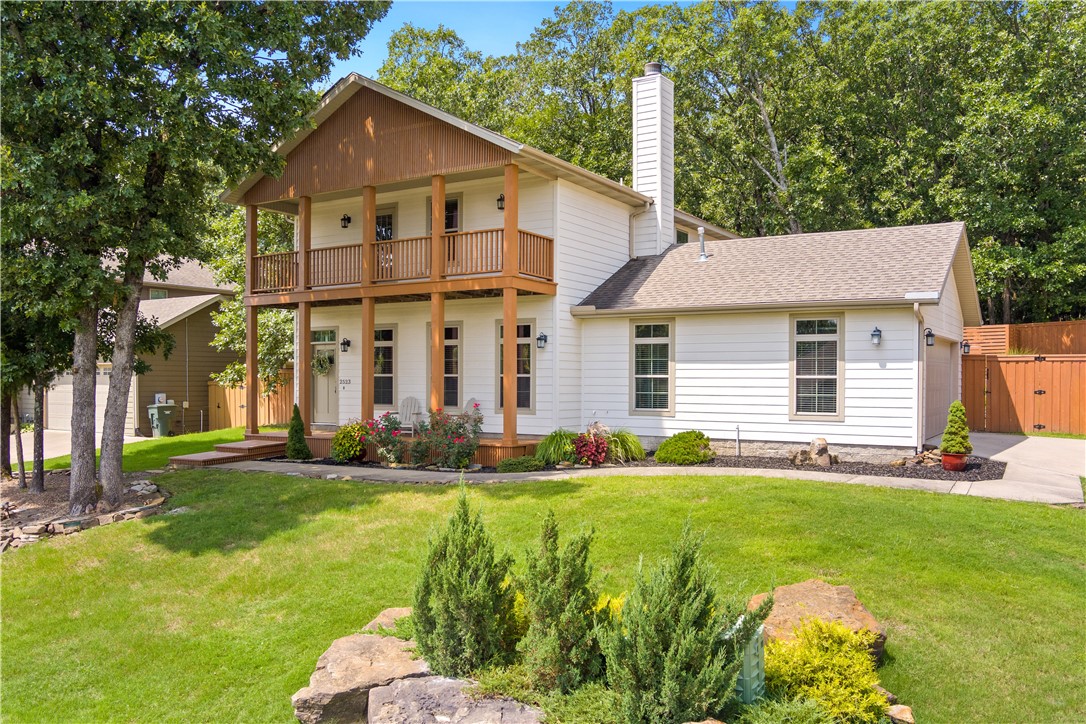 A serene escape awaits in this convenient, central-Fayetteville location. Living up to its name, Wilderness Lane has been thoughtfully designed to meld seamlessly into the natural landscape it borders. A near unbeatable location places this lucky home owner within minutes of the University, Fayetteville square, Gulley Park, and bike trail system. The main level is comprised of the eat-in kitchen, dining, and family room with cozy wood-burning fireplace, half bath and larger family room, and primary suite with large walk-in closet. Upstairs are three more bedrooms and two full baths - the largest bedroom includes an ensuite bath and private covered deck overlooking east Fayetteville. A succulent garden, meditation garden, custom privacy screening built around the hot tub, and attached storage building are features of this well-designed back yard. Solar Panels installed in 2020 reduce monthly energy costs by roughly $60/month! This home is well cared for and move-in ready. See list agent for full features & amenities