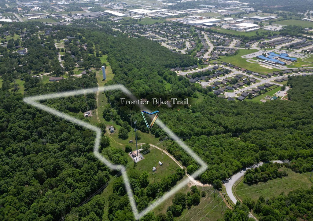 If you have been looking for an opportunity to invest in bicycling in Northwest Arkansas this is your big chance! This 9.19 acre offering borders the Bayyari Park & Mountain Bike Trails" in Springdale. In fact, a small portion of "Frontier Trail" runs right through the property! You could build an adventure park, or a mountain biking resort, or anything else you can think of to serve the thousands of riders that enjoy our area year round! There is even a private road that travels the length of the property! This location is amazing! All it needs is your imagination!