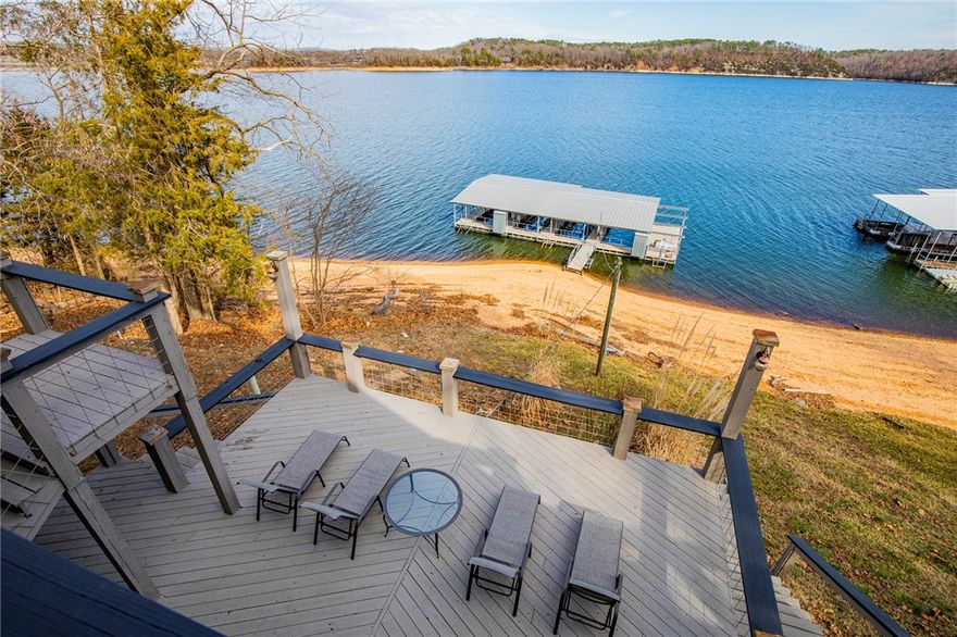 Sensational forever views, a stone’s throw from the shoreline and your own 4 slip dock with electric,  2-10X30 slips with lifts, 2-10X26 slips one with lift, 8x30 swim deck and only 7 miles to downtown Rogers. Turnkey and ready for you to air bnb or for your family and friends to create everlasting memories in. This lake home is packed with a punch and appeal like wood planked and beamed ceiling accents, open main level living lined with windows showcasing the million-dollar views, stunning entertaining space inside and out, second living space in walk out basement and a cozy loft with even more lake views. Lots of updates and upgrades custom soft touch cabinets, new roof, gutters, new windows and tankless water heater, new septic, one HVAC is less than 10 years old and the other is less than 5 years and the list goes on. This is a must see, all furniture and most furnishings and appliances (except for lower level refrigerator and freezer) stay, all you need is your boats and belongings. Come live the lake life!!