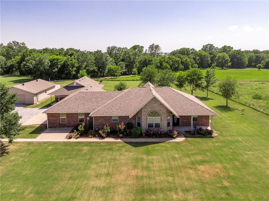 Tucked away on 5.86 bucolic acres at the edge of town, this immaculate property offers the perfect blend of peaceful country living and thoughtful updates. The main home features a 3 bedroom, 2 bath split floor plan with cathedral ceilings in the living room and extensive upgrades throughout—including new carpet, paint, lighting, fixtures, blinds, window screens, HVAC, and more. An attached 1 bedroom, 1 bath apartment provides the ideal setup for guests or multigenerational living, with an open floor plan, butcher block island, and spacious ensuite bedroom. Outside, enjoy a 1,200 square foot cooled and insulated shop with new interior wall finishes, attic ventilation, and lighting. A covered deck overlooks a private backyard filled with birds and wildlife, and a walking path winds around the entire property. With great curb appeal, mature landscaping, and flexibility for a variety of uses, this home is truly move-in ready with room to grow.