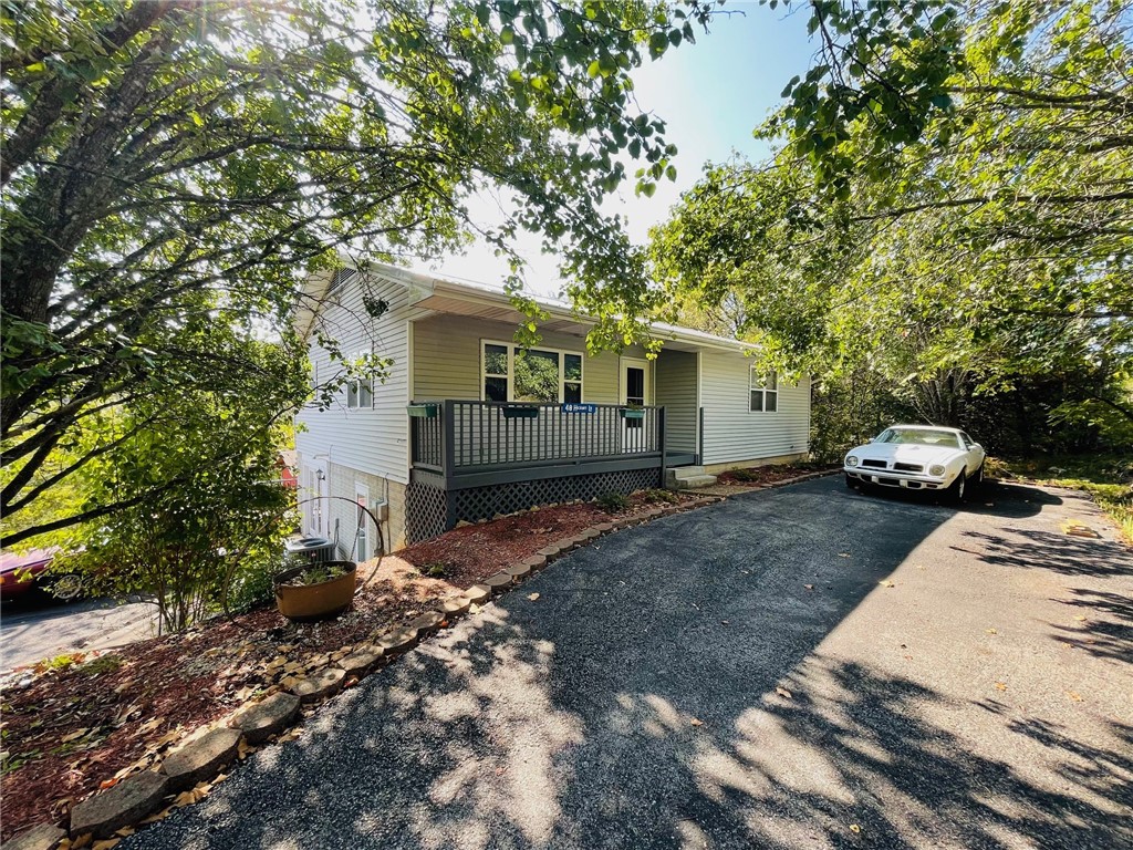 Enjoy beautiful Table Rock Lake with this very nice 3BR, 2 1/5 BA home with a great view off the new deck, top level has large bedroom and bath with whirlpool tub and shower, 1/2 bath in the hall, large eat-in kitchen with dishwasher, electric range/oven, vent, tile floor, Large living room with gas log fireplace LVP flooring, walk out basement level has 2 more bedrooms, 1 bath, large utility room storage and garage that was converted to a game room. There are 2 large storage buildings all setting on 2 lots of privacy totaling 1.8 acres.