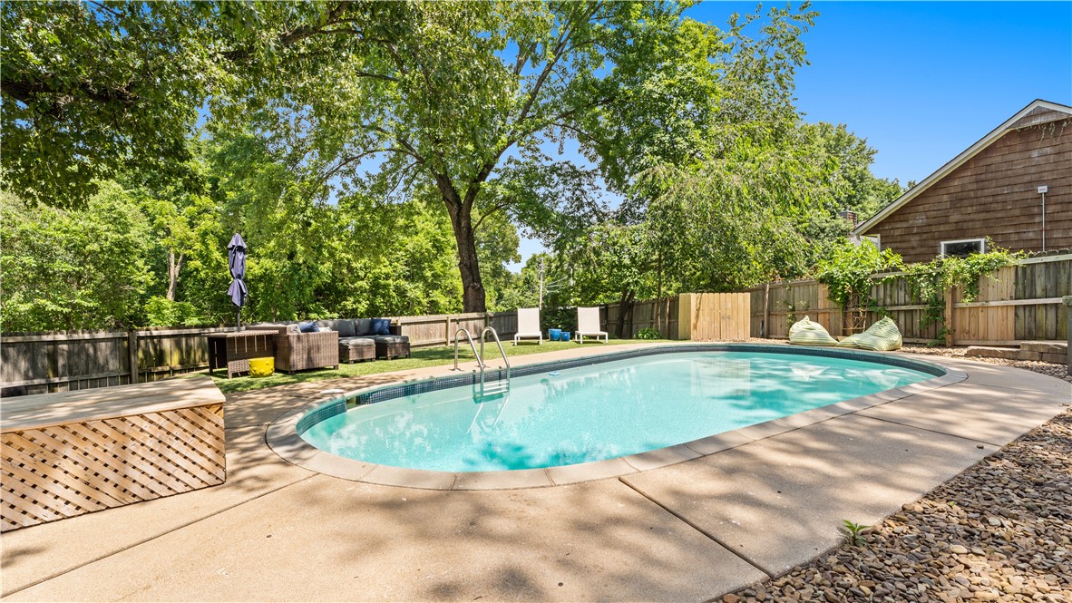 Location cannot be beat! I49, Downtown Bentonville and bike trails all in close proximity to this Hidden Springs subdivision one level home. Large (.46 acre) lot with mature trees has a picturesque outdoor oasis with updated, professionally landscaped surrounding the in ground pool. Inside you will love the modern feel of the vaulted ceilings and skylights in the living room flooding the house with natural light. Hardwood floors, granite counter tops, wood burning fireplace, and two living areas. Kitchen has lots of cabinets with breakfast bar opening to the dining room all freshly painted and move-in ready!