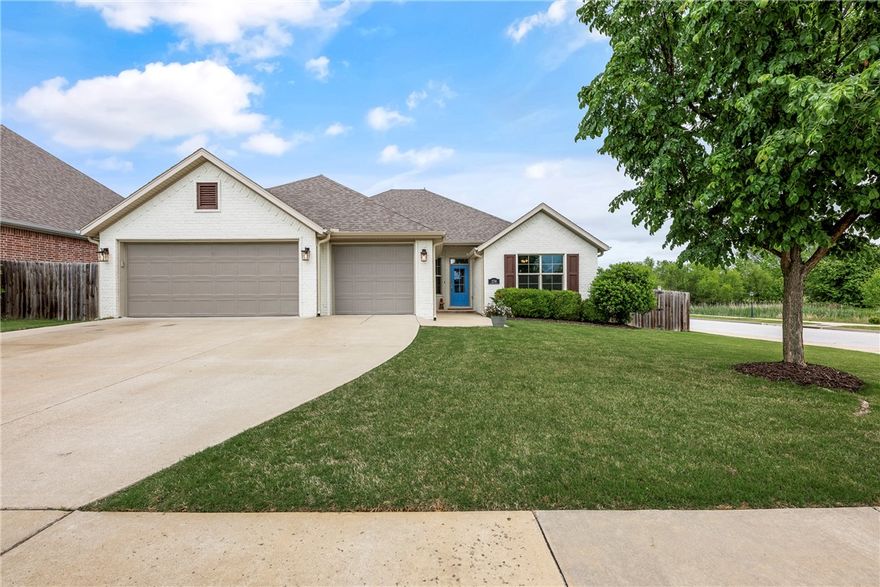 Fresh white curb appeal meets a smart, functional layout in this beautifully maintained 4 bed, 3 bath home on a spacious corner lot. Inside, you’ll find a desirable split floorplan with two bedrooms on each side—ideal for privacy and flexibility. A formal dining room sits at the front of the home, while the large living area opens seamlessly to the kitchen, creating an inviting space for everyday living and entertaining. The kitchen features granite countertops, ample cabinet storage, pantry, refrigerator, and an island with bar seating. Cozy up by the gas fireplace or step outside to the oversized covered back deck—perfect for relaxing or hosting. All just minutes from I-49 for easy access to everything Northwest Arkansas has to offer.