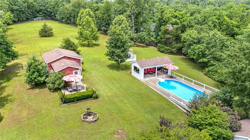 Pull up to your private oasis in Bella Vista, with NO POA RESTRICTIONS! This lovely and pristine property overlooks the 2nd hole on Scotsdale Golf Course. Surrounded by lush trees and so much peace! This New England inspired farmhouse cottage is stunning, with it's two office areas, large and open living room and kitchen and SO much natural light. Spacious and cozy bedrooms with large windows, ample closet space for you, your family and guest. The land is stunning with its pool and open cabana, turn key barn, above ground garden, barn with usable indoor space and firepit. Two covered porches and a pea stone courtyard too! Animals are permitted! Land uses are abundant from hobby farm to a new subdivision to your own special retreat. Imagine living in the center of Bella Vista, with ALL of this! So many options to make this charmer your very own. This one is so special!