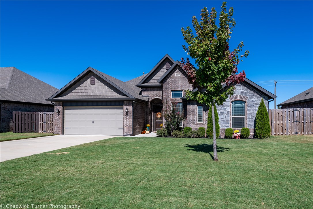 This 2017 1-story, full brick/stone home is almost brand new & organized, has 4-bedrooms, 2.5-baths, 2-car attached garage with a workbench that conveys, wood fenced backyard with a covered back patio & a fireplace. Landscaped front yard, covered front exterior entry with a foyer, gas fireplace in living room, a eat-in kitchen with solid wood cabinets, large island, granite counter tops & good sized pantry, separate laundry room, split floorplan with spacious master bedroom & master bath suite with two sinks, jetted tub & separate shower, U-shaped walk-in closet that allows more natural light from the window in back & lots of extra room for more clothes. Two more bedrooms off the front and one in the middle & when you walk into the foyer you get a favorite view of the back patio overlooking
the field that'll be a Rogers City Park someday. Refrigerator, Washer/Dryer, Patio TV & some furniture are negotiable. All the major components are in working condition & Seller offering Home Warranty with acceptable offers.
