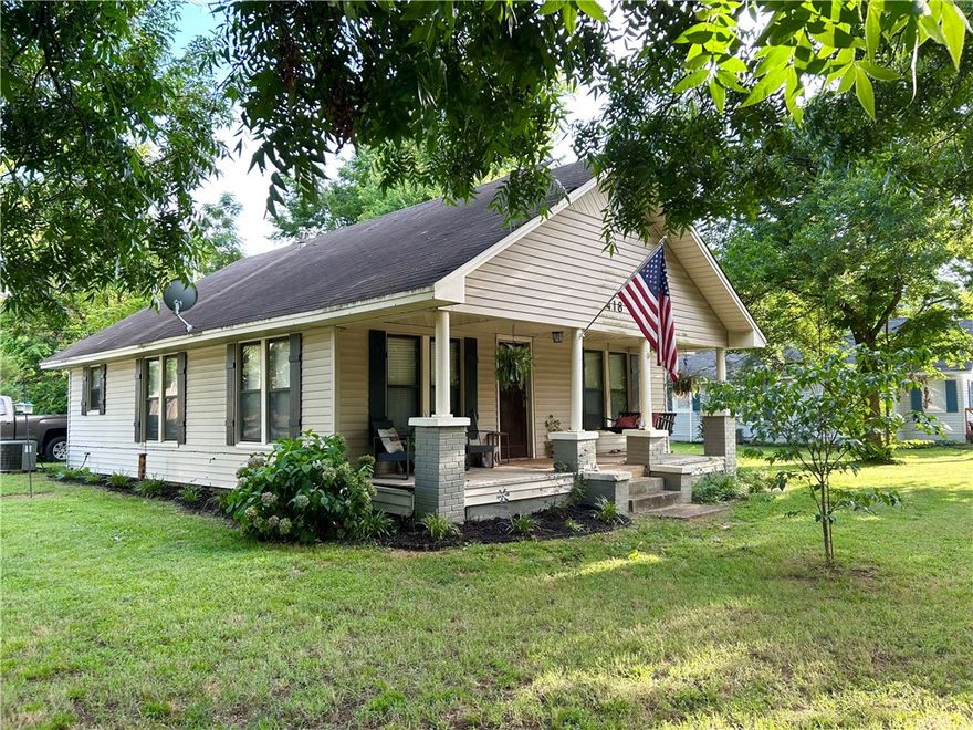 This charming 3 bedroom home sits on a corner lot possibly large enough to subdivide in a wonderful location just about a mile from Arkansas Tech University.  Recently updated with all new plumbing, electrical, flooring, paint and finish, this house is move-in ready.  New roof just installed (Aug 25) The spacious front porch gives a wonderful place to relax on those breezy summer evenings with porch swing included and a backyard big enough for a large garden.  Don't miss your chance, schedule your showing today!