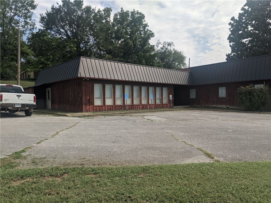 Commercial/Residential Opportunity – Over 400 Ft. of Road Frontage! 
Excellent visibility and location just off Hwy 62/65 with approx. 1.70 acres m/l and over 400 feet of road frontage. Property is zoned R-3 Medium Density Residential and C-2 Office Commercial, offering flexibility for a wide variety of uses.  The existing building was previously used as a senior center and features: 2,818 sq. ft. of space, One single-stall bathroom and one two-stall bathroom, Kitchen area for food service or breakroom, Large open areas adaptable for office, retail, community center, or redevelopment,  With its convenient access, generous lot size, and multiple zoning options, this property is ideal for a wide range of commercial or residential projects. Prime location just off a major highway – perfect for maximizing exposure and accessibility!