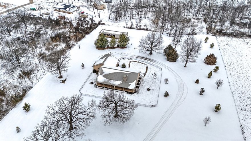 This beautifully maintained, one owner home is nestled on 5 peaceful level acres in Gravette, located minutes from the I-49 Bypass. This open concept floor plan with beautiful upgrades blend comfort, functionality and timeless style. The interior features a designated office, wood-burning fireplace, crown molding throughout, insulated pocket doors, casement windows, custom built-ins & generous walk-in closets. Offering energy efficiency with a geothermal heating & air unit tied into the Marathon water heater that provides hot water recirculation. The 3 car garage includes a dedicated dog washing/grooming room and storage/utility room. The exterior showcases durable rock veneer and Hardie board siding and extended front & back covered porches, offering classic curb appeal. A 30' X 25' storage/workshop building with water & electricity provides endless possibilities and has enough room for a vehicle. Enjoy the privacy and beauty that comes with acreage living with an easy, 20 minute drive to Downtown Bentonville!